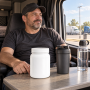 Illustrative adult truck driver preparing mixing essentials beside a closed Roadwell tub in a parked truck.